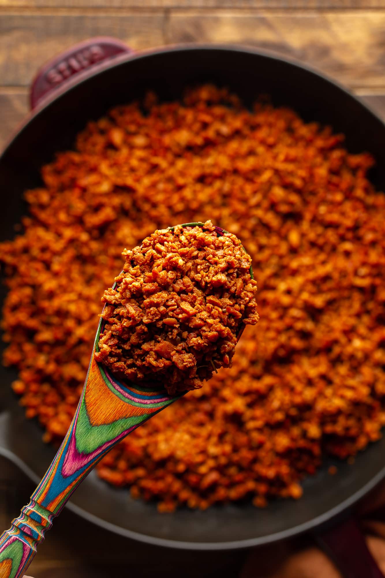 First in a wooden spoon that holds a vegan chorizo spoon.